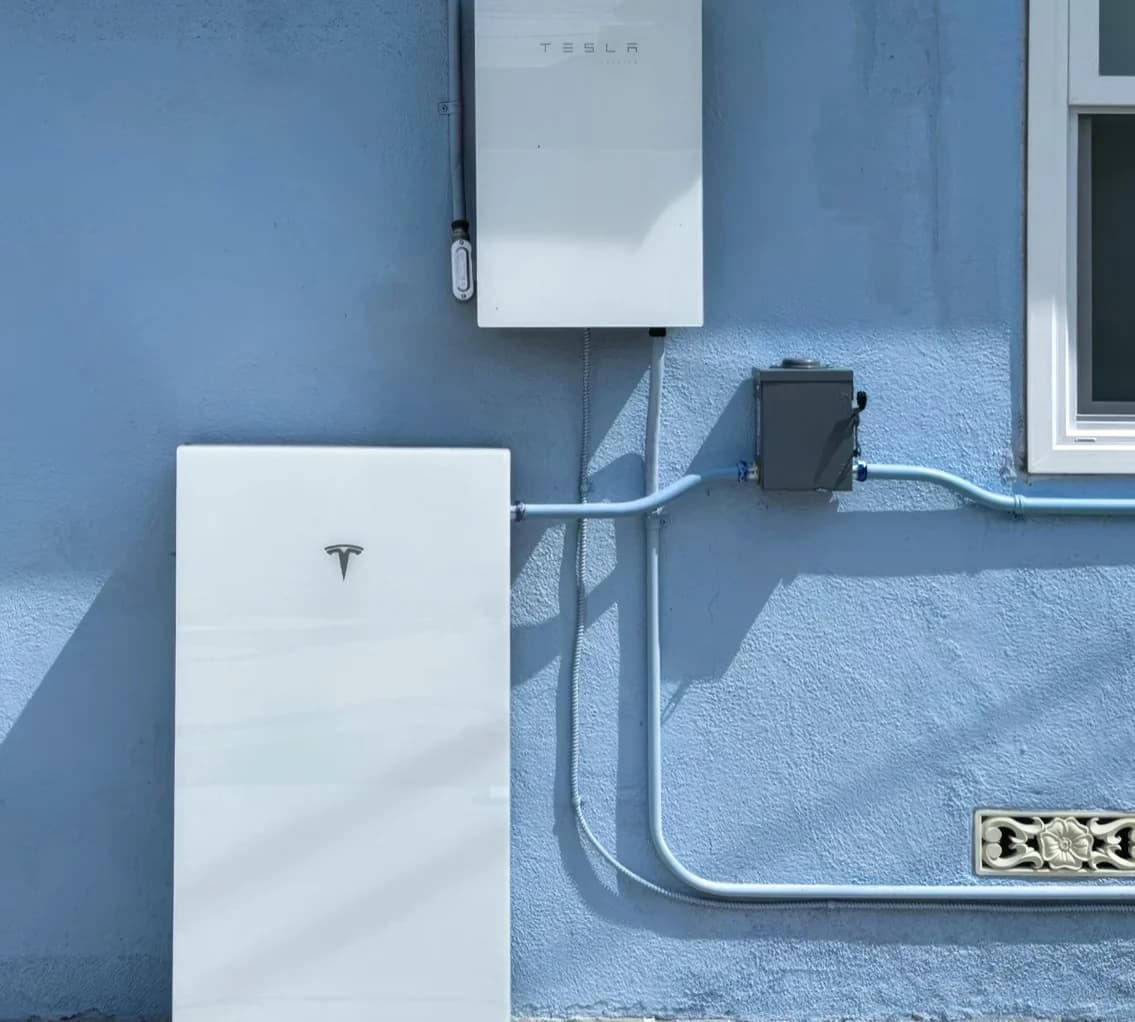 Tesla Powerwall installed on the exterior wall of a home